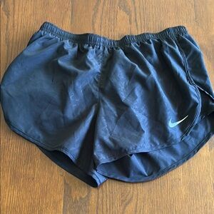 Nike Junior Black Running Shorts with zipper pocket in the middle of the shorts
